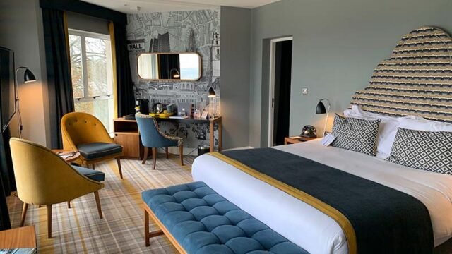 room with bed and chairs